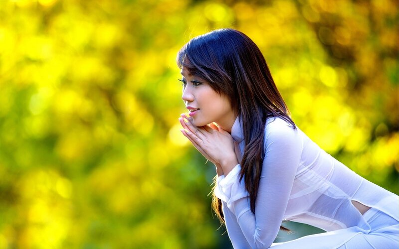 woman in white against yellow background