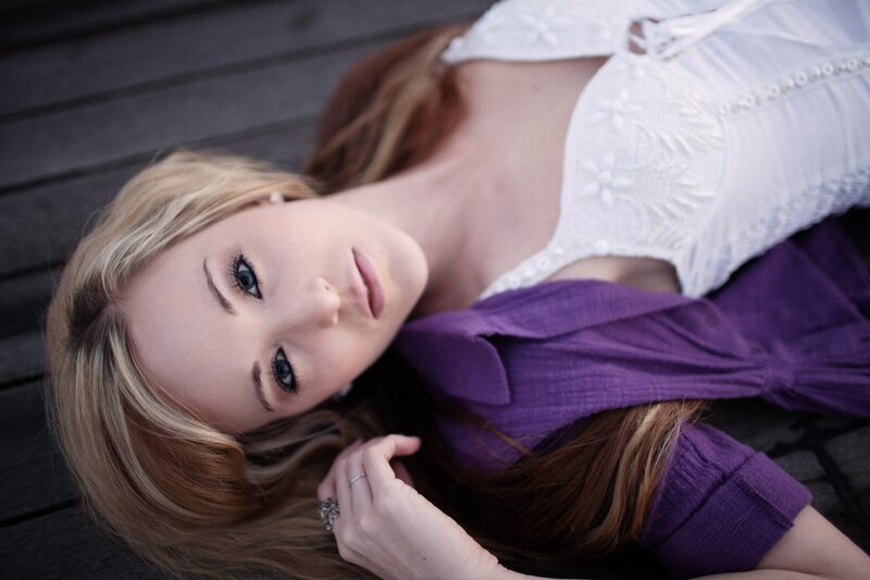 woman in white and purple lying down