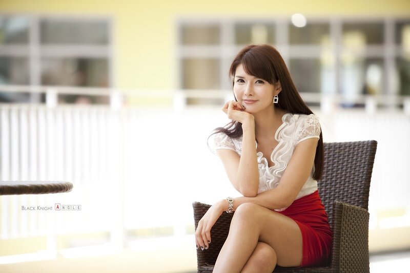 woman in white and red sitting