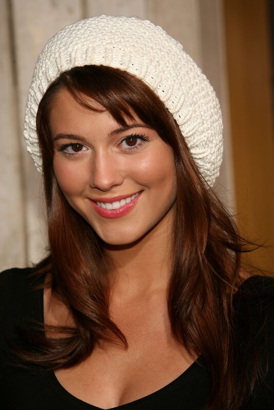 woman in white beanie smiling