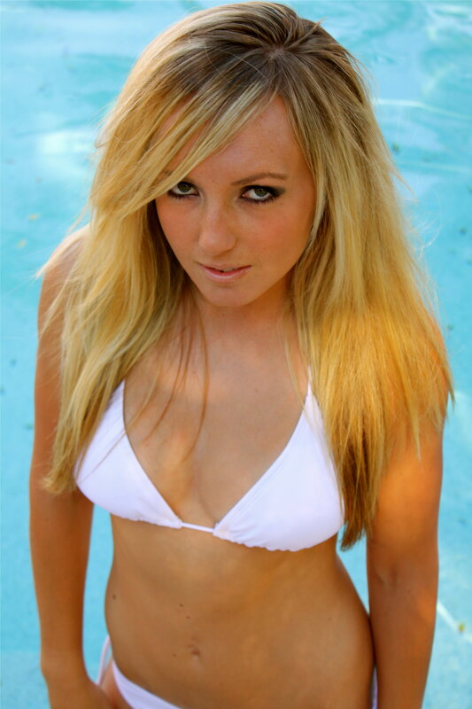 woman in white bikini by pool