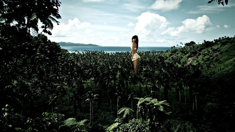 woman in white bikini on tropical hill