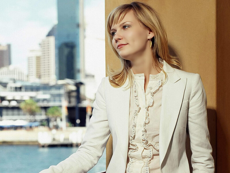 woman in white blazer by water
