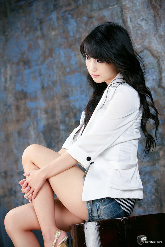 woman in white blazer sitting