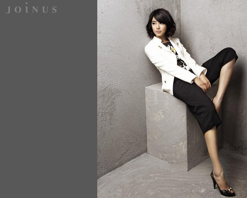 woman in white blazer sitting