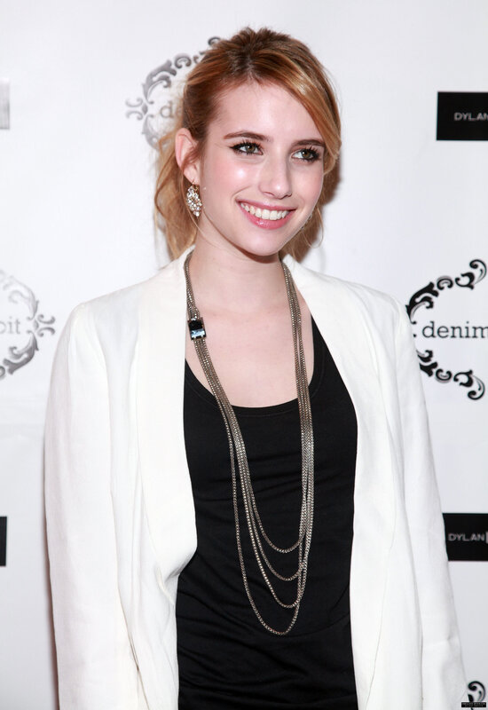 woman in white blazer smiling