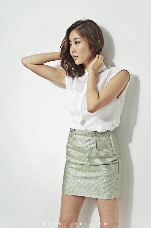 woman in white blouse and green skirt