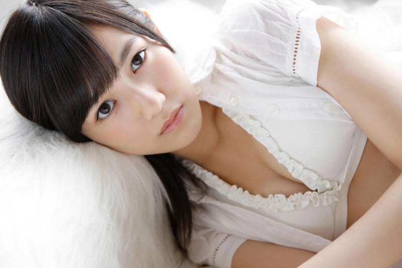 woman in white blouse lying down