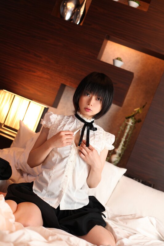 woman in white blouse on bed