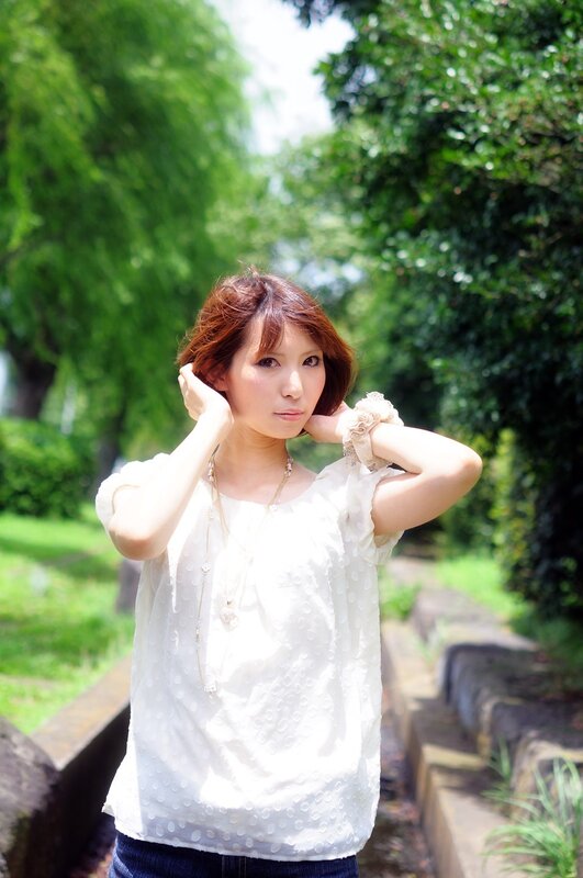 Woman in white blouse outdoors