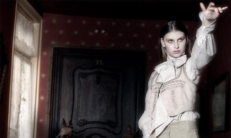 woman in white blouse pointing