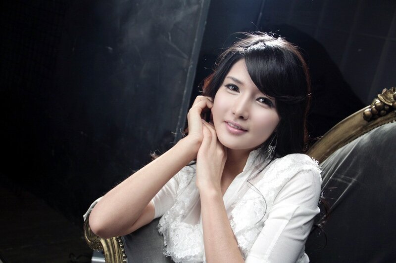 woman in white blouse sitting