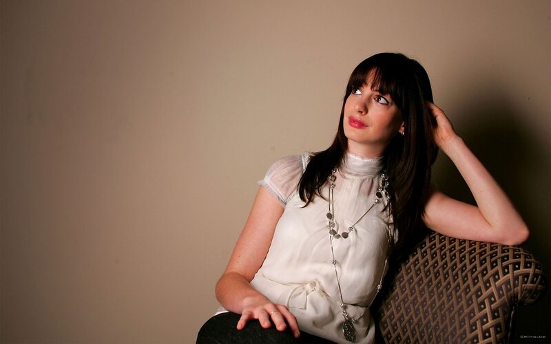 woman in white blouse sitting