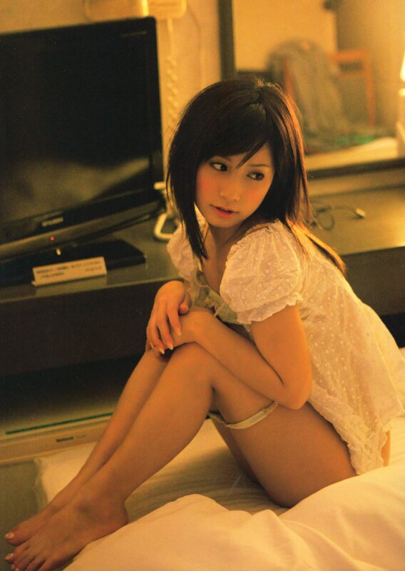 woman in white blouse sitting on bed