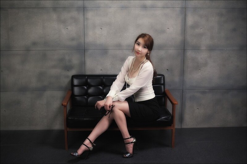 woman in white blouse sitting on couch