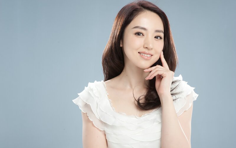 woman in white blouse smiling