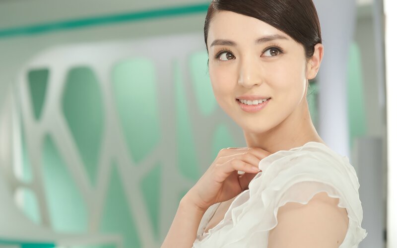 woman in white blouse smiling