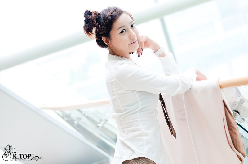 woman in white blouse smiling