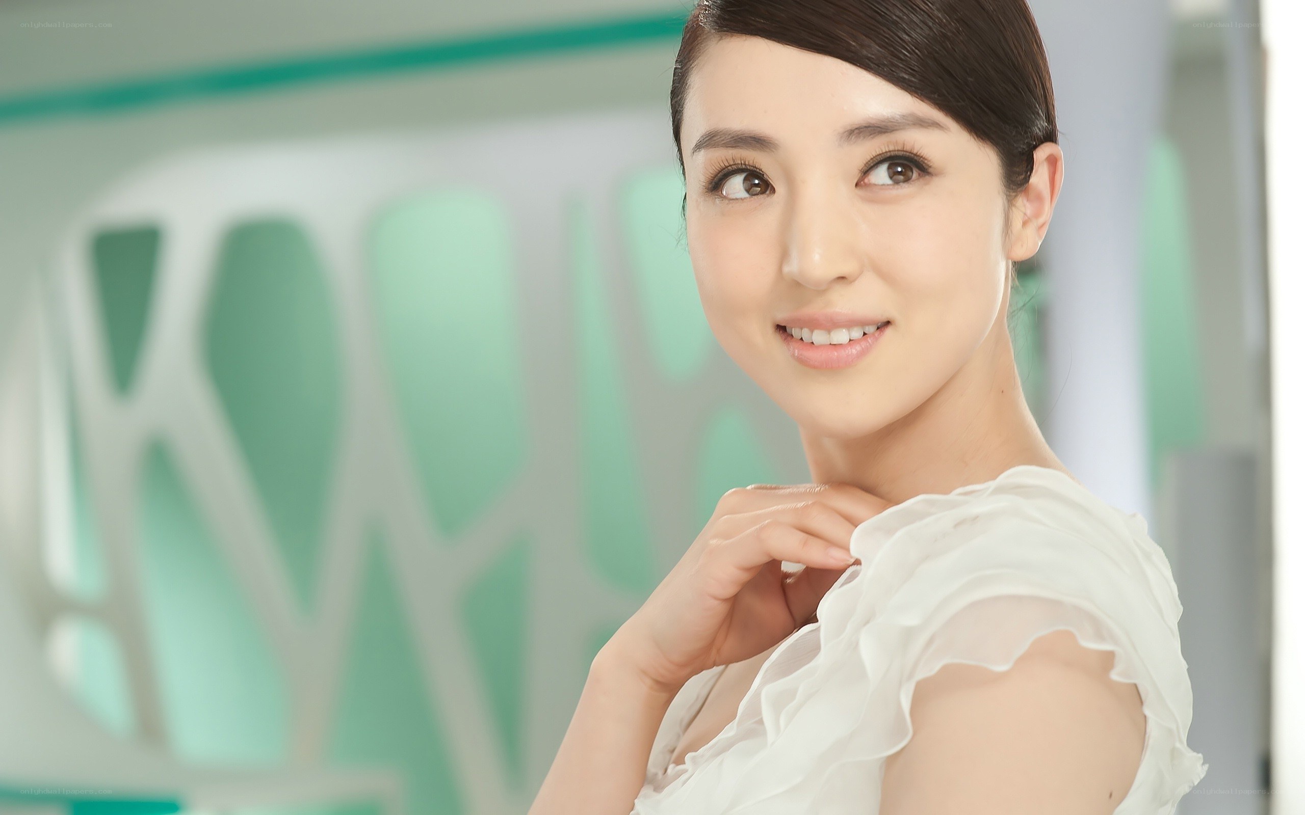 woman in white blouse smiling