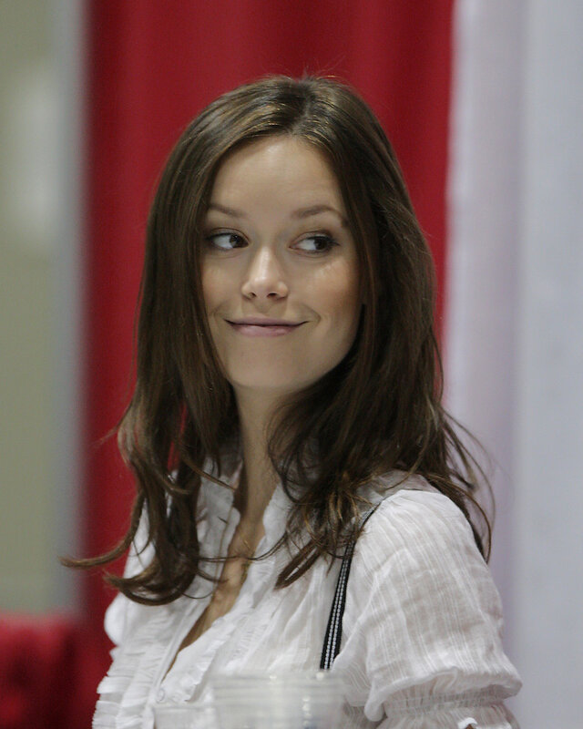 woman in white blouse smiling