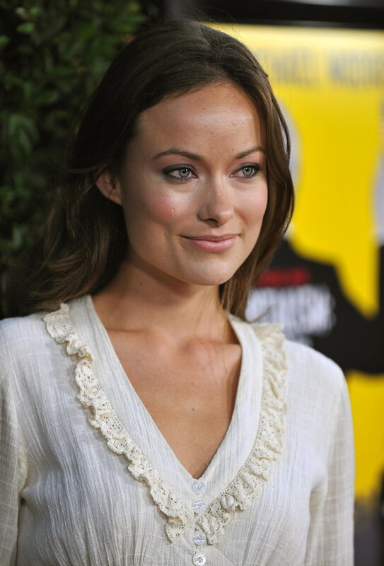 woman in white blouse smiling