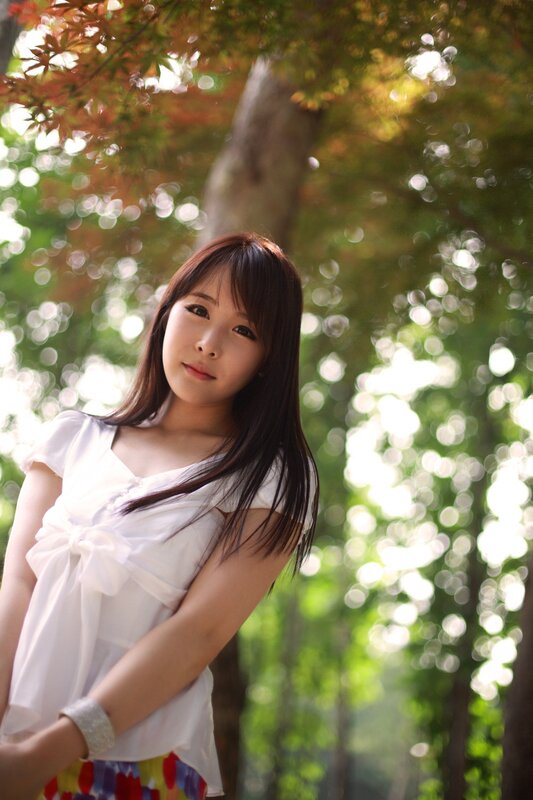 woman in white blouse under trees