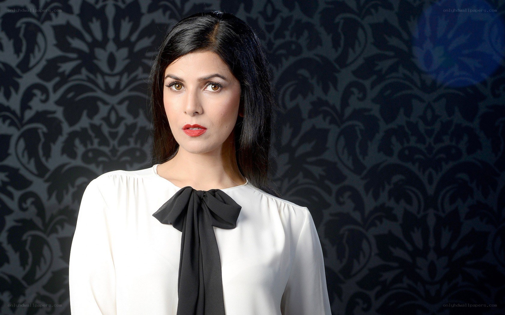woman in white blouse with black bow