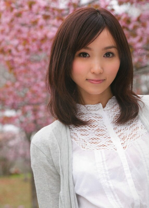 woman in white blouse with cherry blossoms