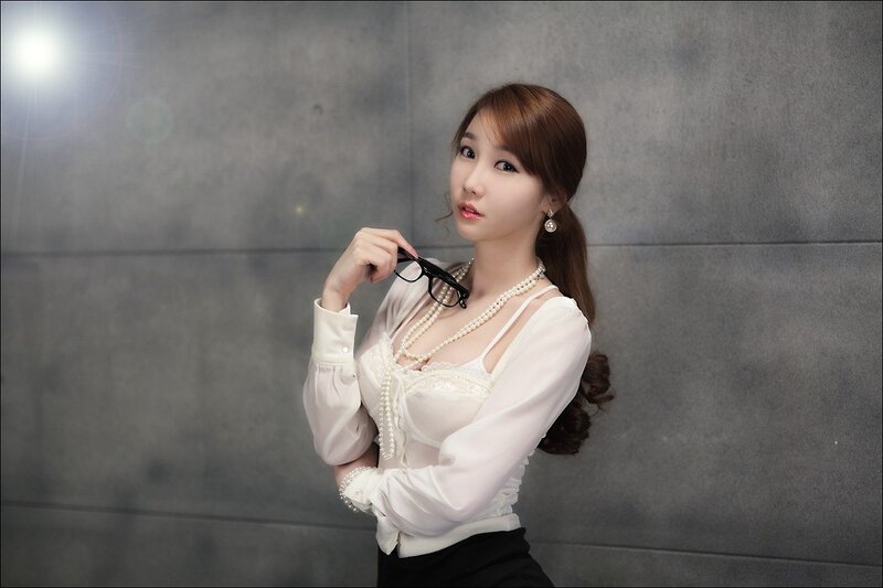 woman in white blouse with pearls