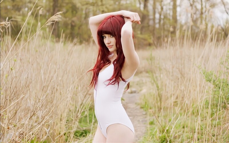 Woman in white bodysuit outdoors