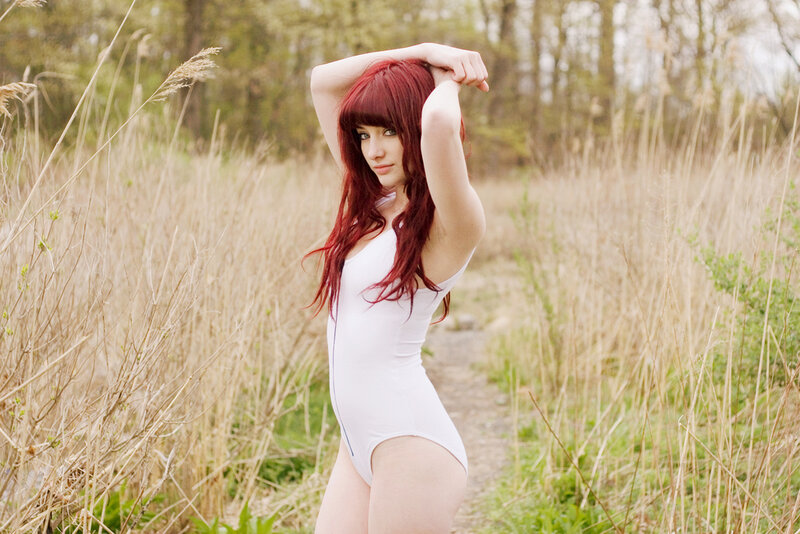 Woman in white bodysuit outdoors