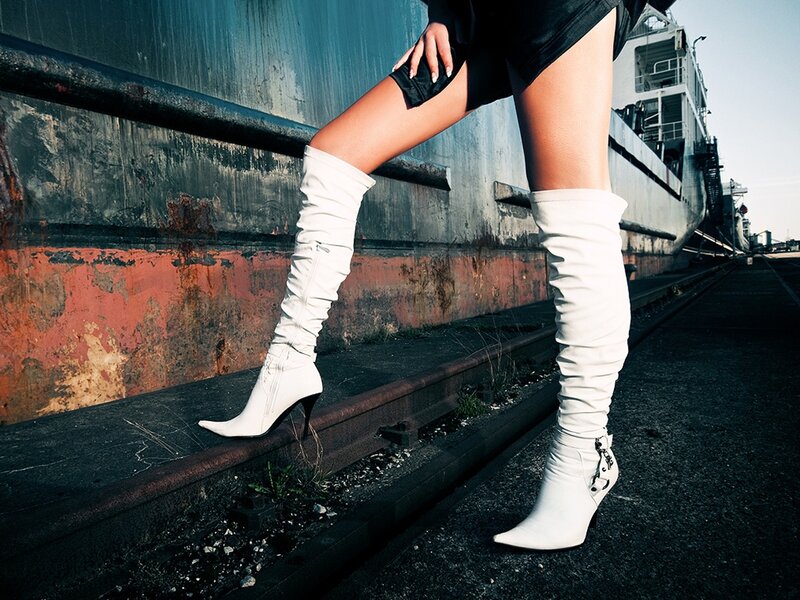 woman in white boots on dock