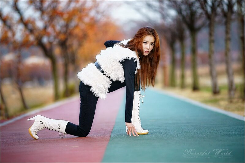 woman in white boots on path
