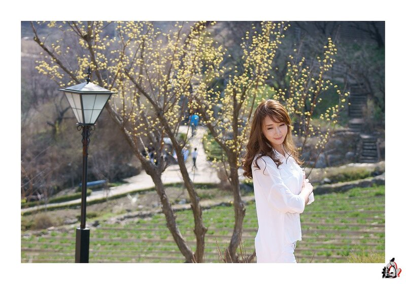Woman in white by blooming tree