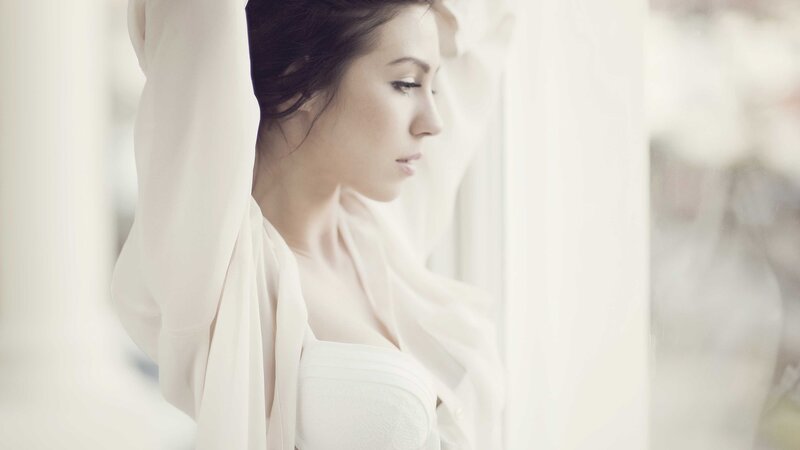 woman in white by window