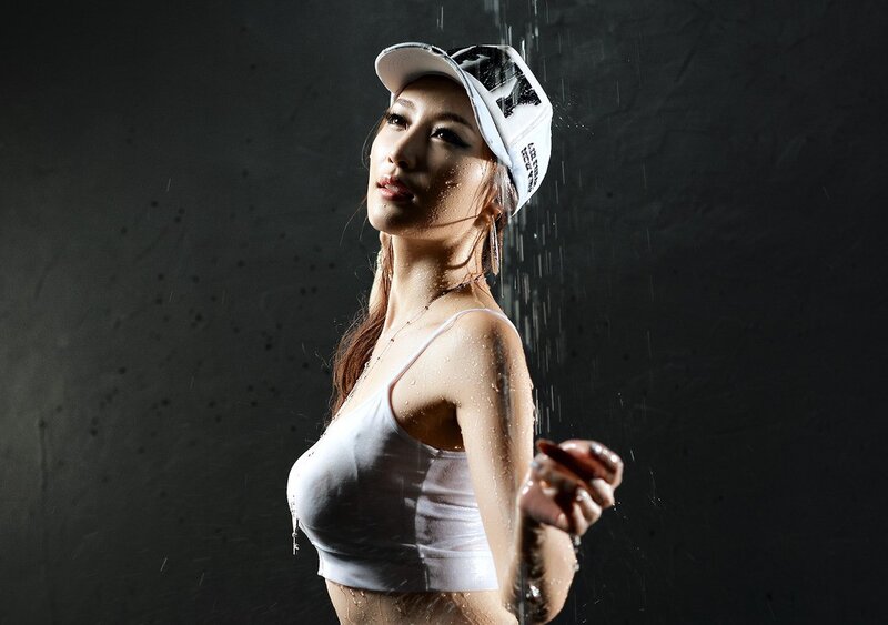 woman in white cap under water spray