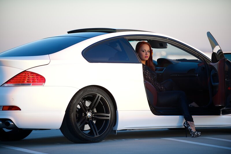woman in white car at sunset