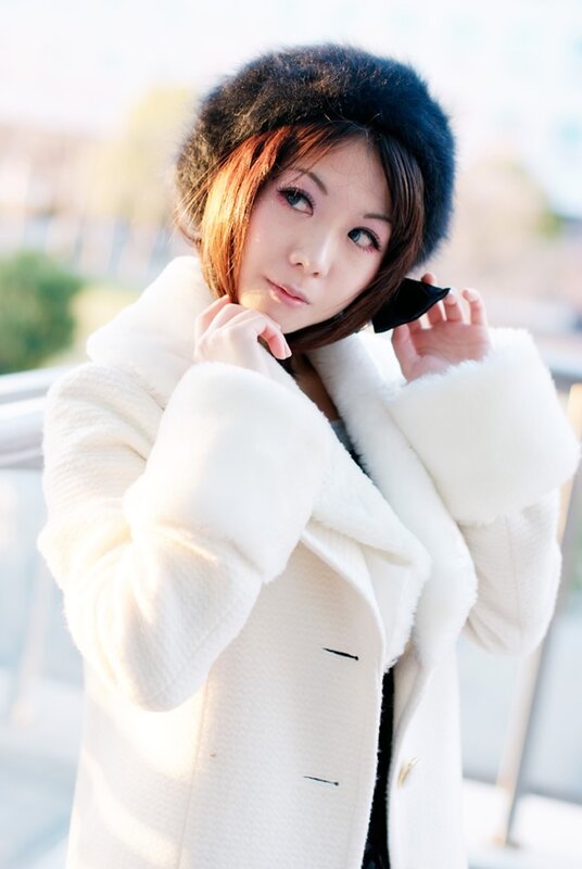 woman in white coat and hat