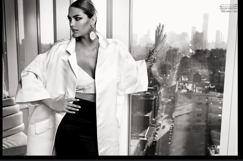 woman in white coat by window