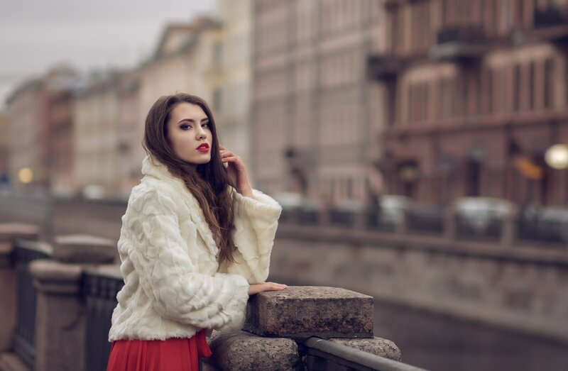 Woman in White Coat — Contemplative