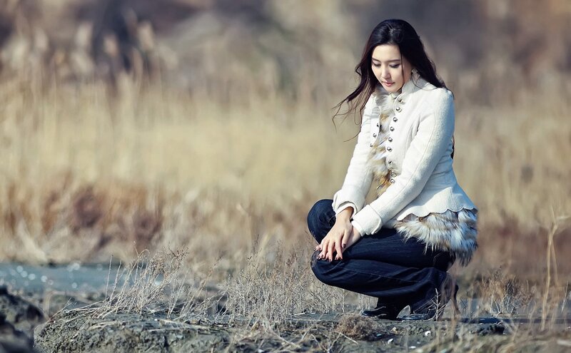 woman in white coat crouching