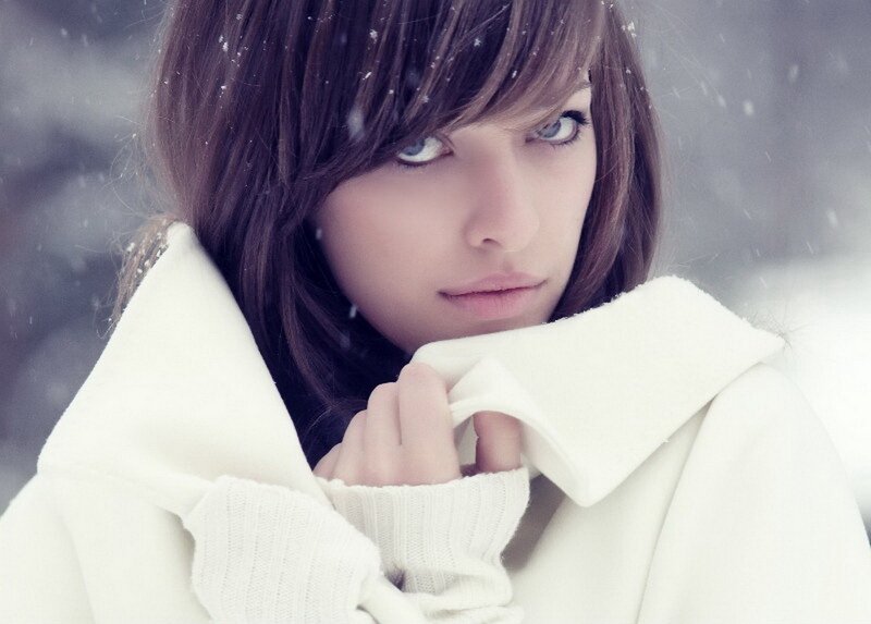 woman in white coat during snow