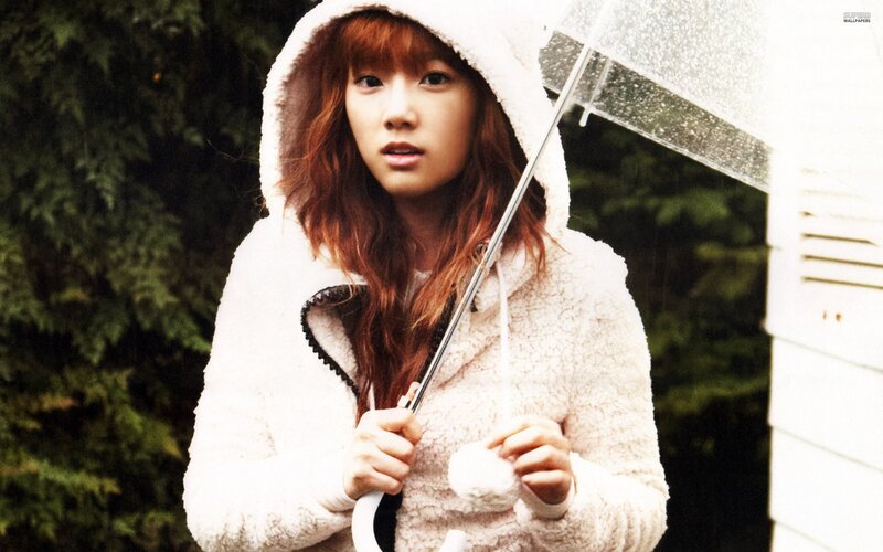 woman in white coat holding umbrella