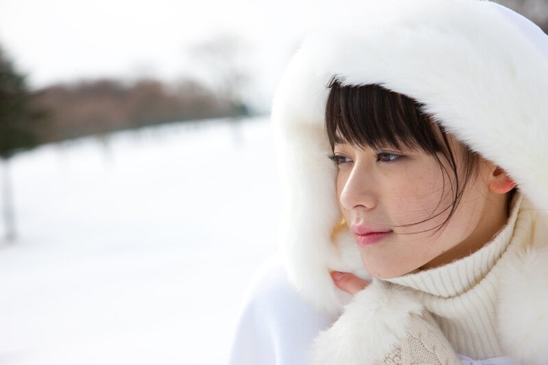 woman in white coat in snow