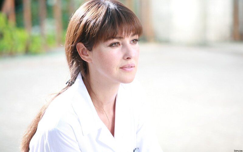 woman in white coat looking away
