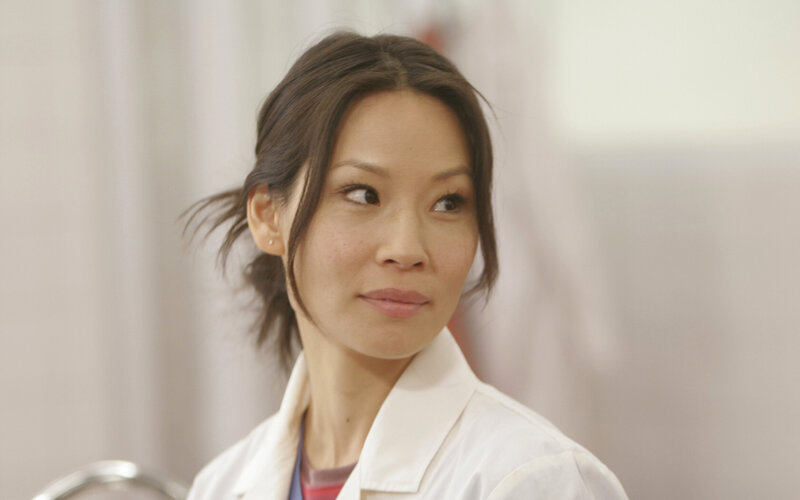 woman in white coat looking sideways