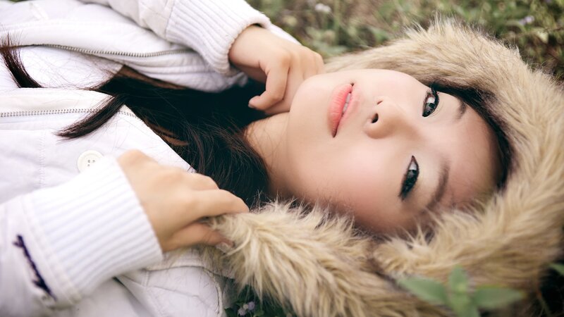 woman in white coat lying down