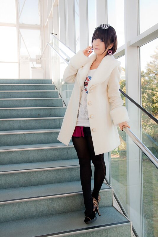 Woman in white coat on stairs