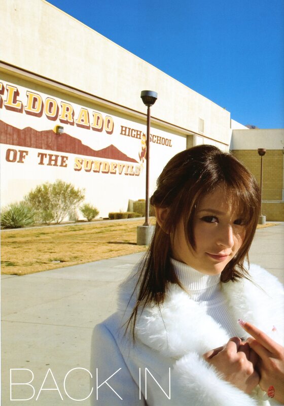 woman in white coat outside school