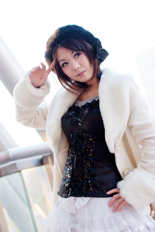 woman in white coat posing